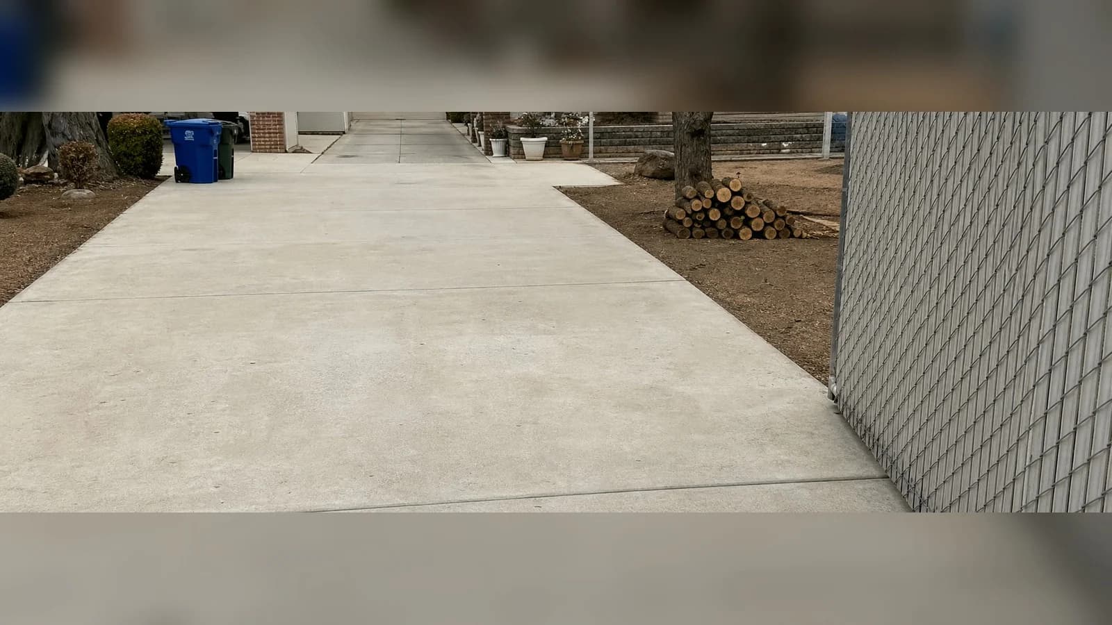 Lancaster driveway after cleanup with yard debris removed and the concrete swept.