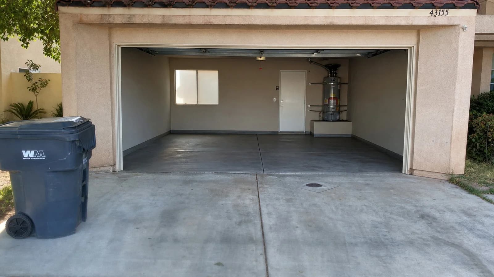 Palmdale garage after cleanup with the driveway and garage floor cleared.